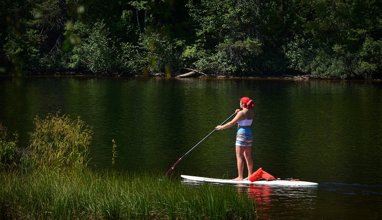 Girl paddle boarding in the summer